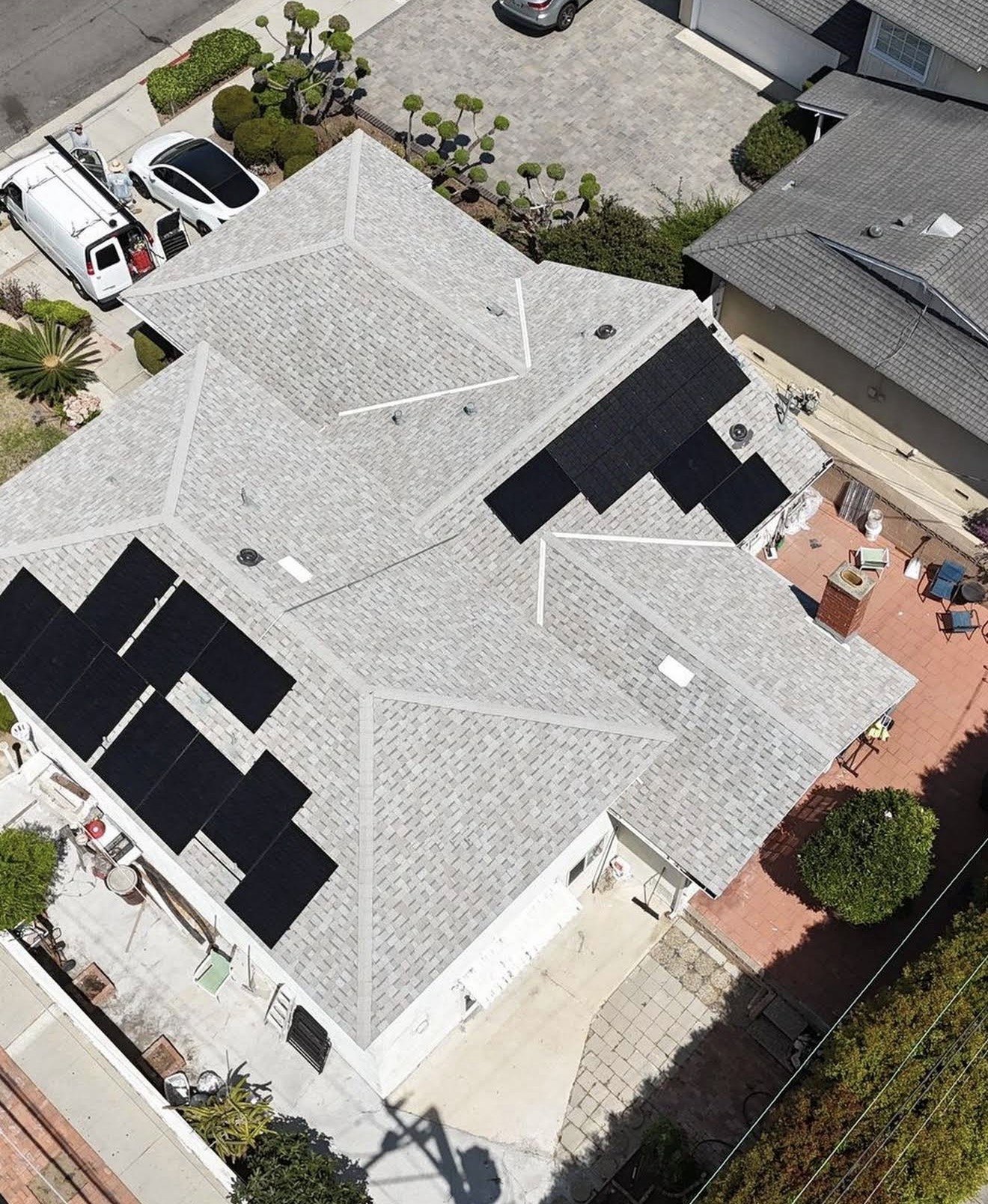 Aerial view of completed shingle roof replacement with solar array, Santa Ana, CA